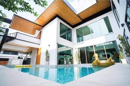 Modern house with swimming pool and floating inflatable toy