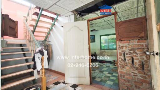 Spacious entryway with staircase and eclectic design elements