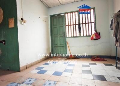 Simple interior room with tiled floor and green door