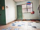 Simple interior room with tiled floor and green door