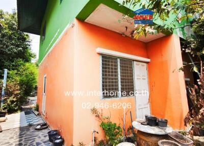Orange exterior of a small residential building