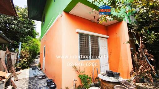 Orange exterior of a small residential building