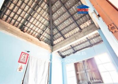 Interior view of a building with unfinished ceiling and walls