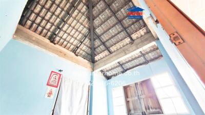 Interior view of a building with unfinished ceiling and walls