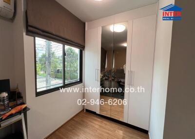 Compact bedroom with large mirrored wardrobe and view of the surroundings through a large window