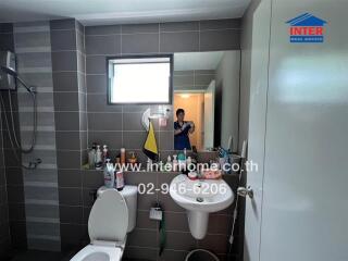 Modern bathroom interior with gray tiles and essential fixtures