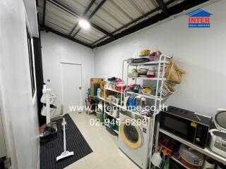 Organized utility room with storage shelving and appliances