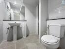 Modern bathroom with white tiles and essential fixtures