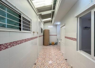 Tiled corridor in residential building with natural light