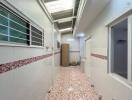 Tiled corridor in residential building with natural light