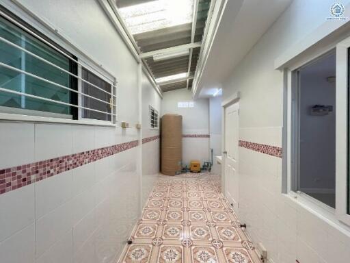 Tiled corridor in residential building with natural light