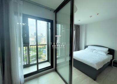 Modern bedroom with city view and balcony access