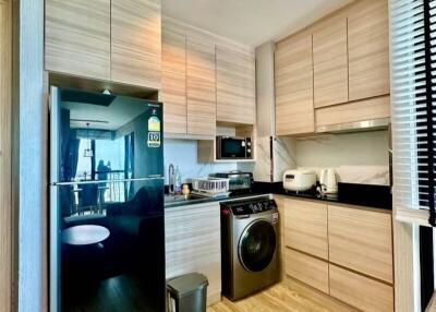 Modern kitchen with integrated appliances and wooden cabinetry
