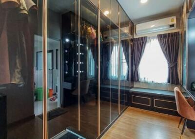 Stylish modern bedroom with large mirror wardrobe and makeup vanity