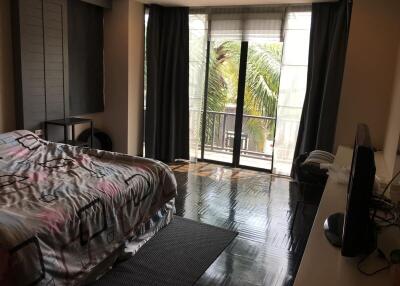 Spacious bedroom with large windows and balcony access