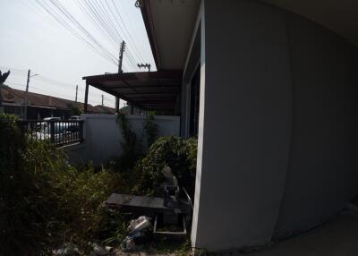 Side view of a residential house showing partial facade and outdoor space