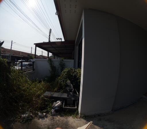 Side view of a residential house showing partial facade and outdoor space