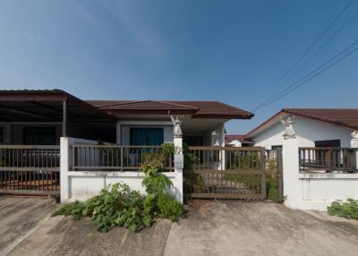 Suburban single-story house with a detached carport and fenced yard