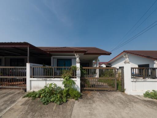 Suburban single-story house with a detached carport and fenced yard