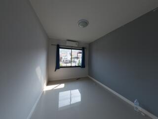 Spacious and well-lit empty bedroom with large window