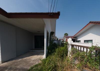 Exterior view of a modern single-story house with a spacious concrete porch