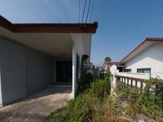 Exterior view of a modern single-story house with a spacious concrete porch