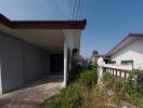 Exterior view of a modern single-story house with a spacious concrete porch