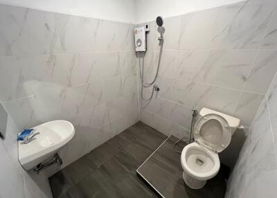 Compact modern bathroom with white and grey tiles