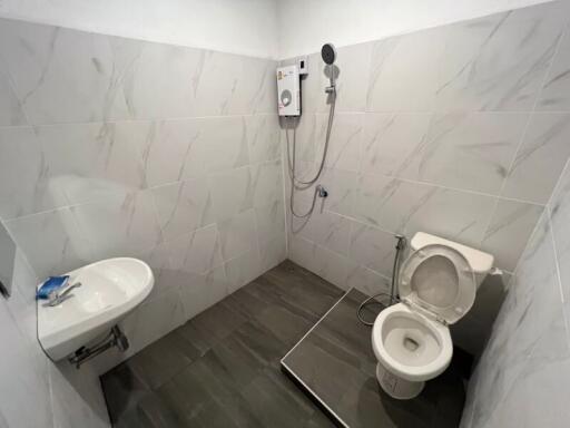 Compact modern bathroom with white and grey tiles