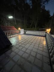 Night view of a spacious balcony with ambient lighting