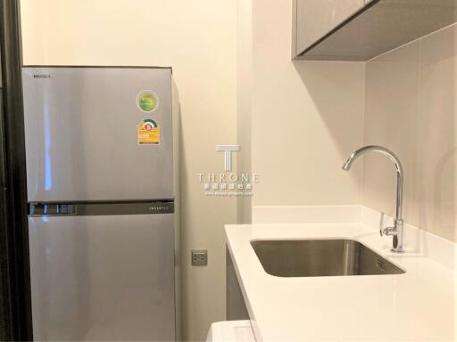 Modern compact kitchen with stainless steel refrigerator and sink