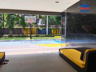 Luxurious indoor recreational space with basketball court and modern seating