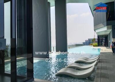 Modern infinity pool with skyline views at luxury apartment complex