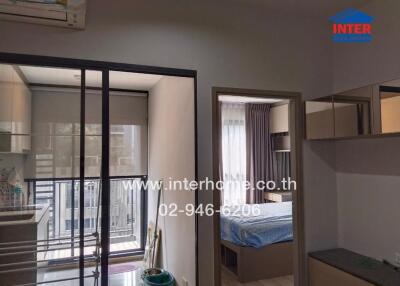 Modern bedroom with sliding door to balcony and view into adjacent room