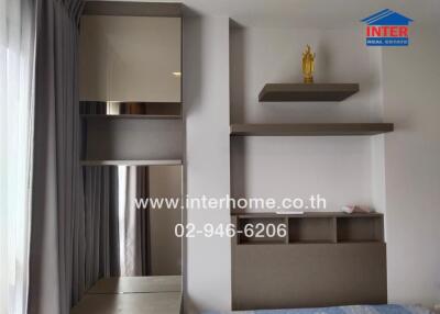 Modern bedroom with shelving units and decorative statue