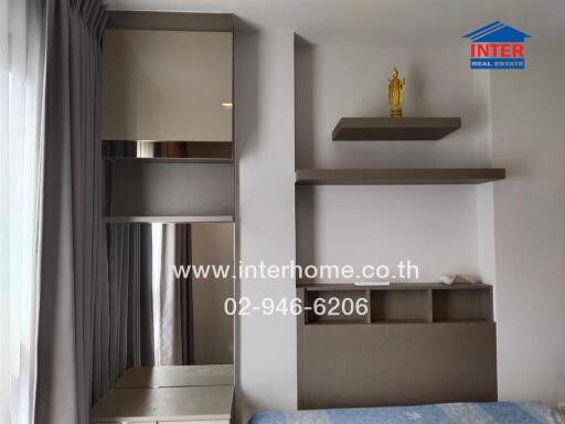 Modern bedroom with shelving units and decorative statue