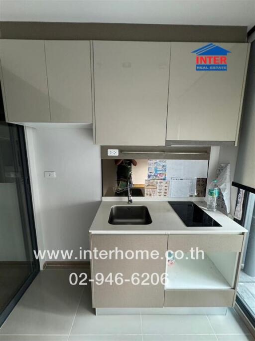 Modern kitchen interior with neutral tone cabinets and a central island