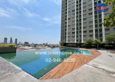 Sunny pool area with city skyline views, surrounded by high-rise buildings