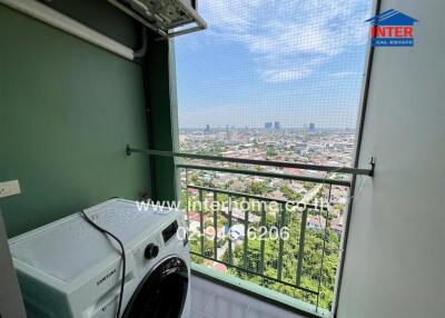 High-rise apartment balcony with city view and washing machine