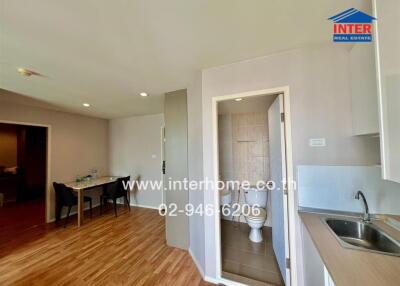 Spacious open-plan kitchen and dining area with modern appliances and ample lighting