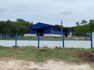 Blue single-story house with surrounding fence