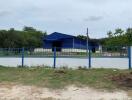 Blue single-story house with surrounding fence