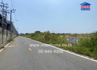 Rural roadside with land for sale sign