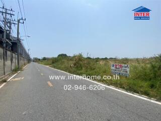 Rural roadside with land for sale sign