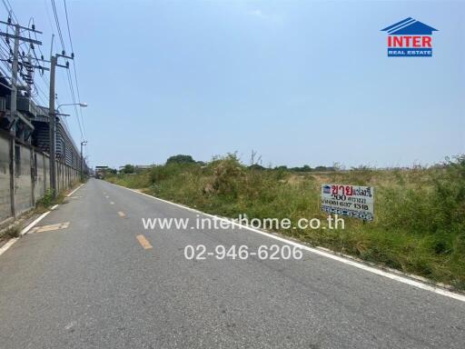 Rural roadside with land for sale sign