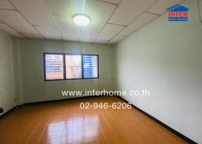 Spacious empty bedroom with large windows and tiled floor