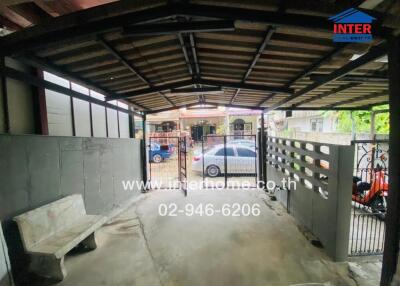 Spacious covered garage with parking space and secure gate