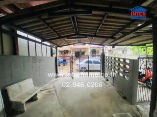 Spacious covered garage with parking space and secure gate