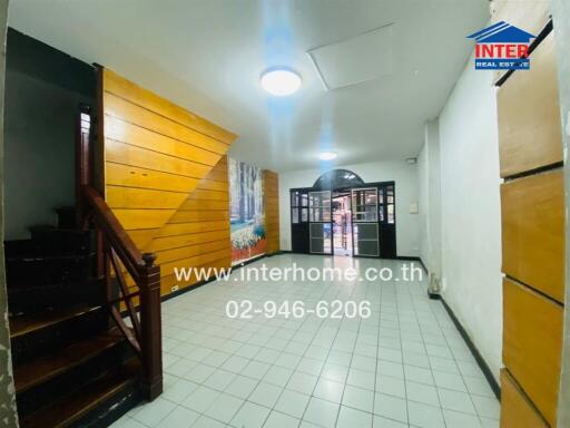 Spacious hallway with wooden staircase and modern lighting