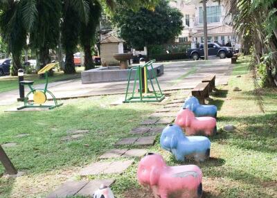 Common outdoor play area with colorful animal sculptures and exercise equipment